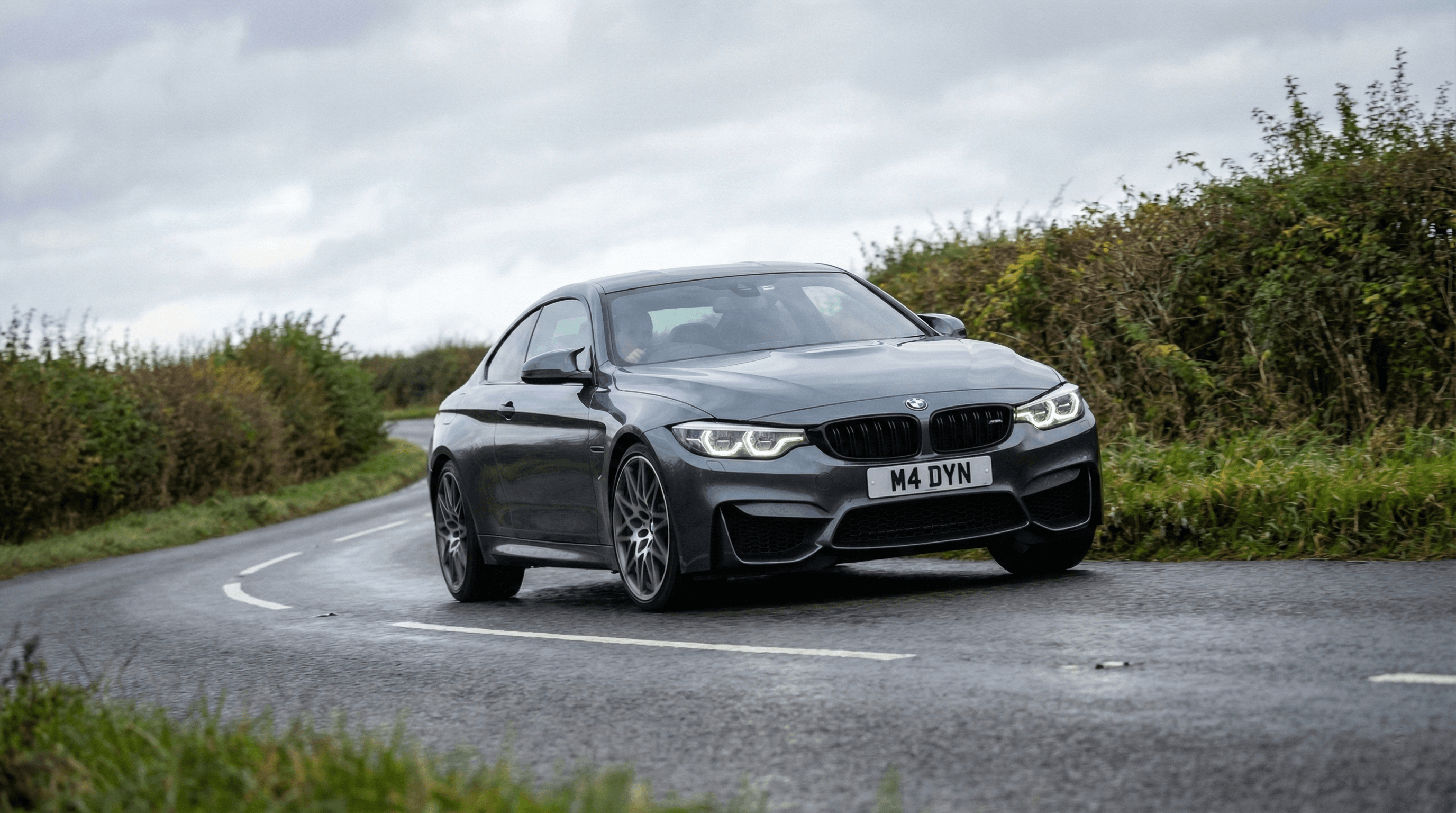 BMW M demonstrating chassis balance on a UK road