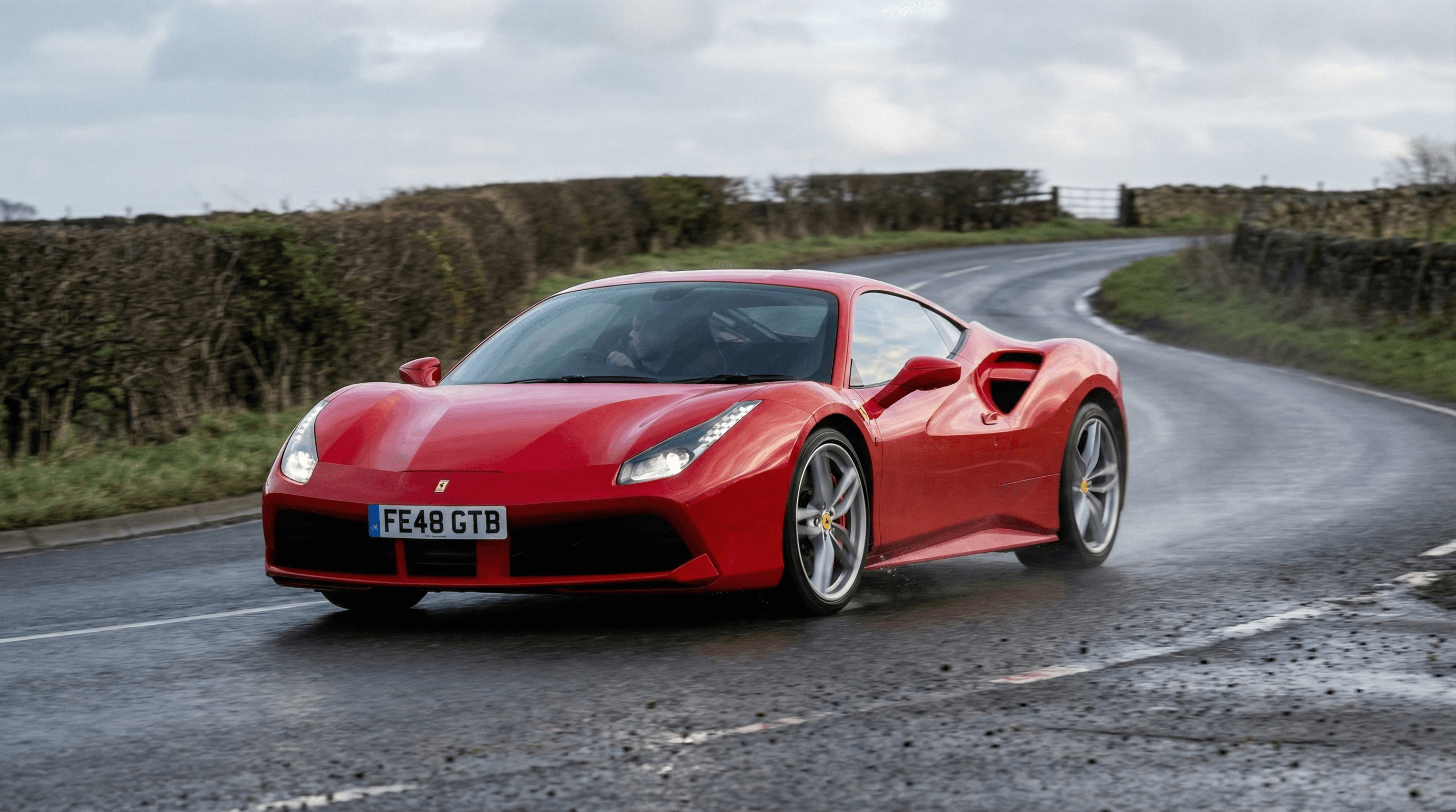 Ferrari mid-engine supercar on a UK road